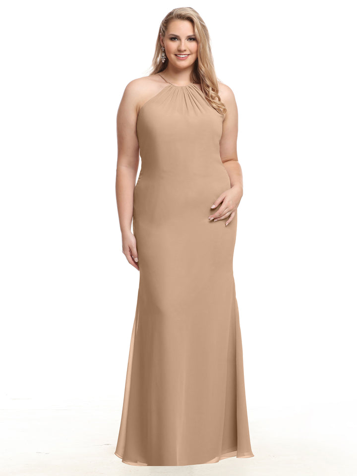 A woman stands smiling against a white background, modeling the Avery Austin TH-80083—a sleeveless, floor-length tan chiffon dress with a halter neckline and gently flared skirt.
