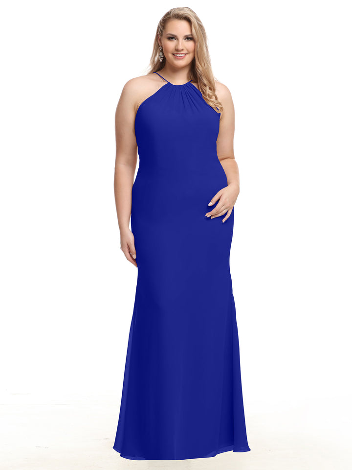 A woman with long blonde hair is standing and smiling against a plain white background, wearing the Avery Austin 80083 sleeveless, floor-length cobalt chiffon halter dress.