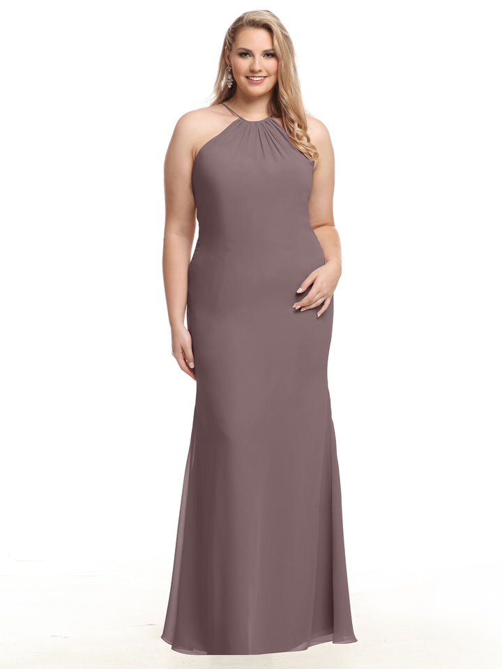 A woman smiles against a white background wearing Avery Austin’s 80083, a sleeveless, floor-length mauve halter dress featuring a keyhole back.