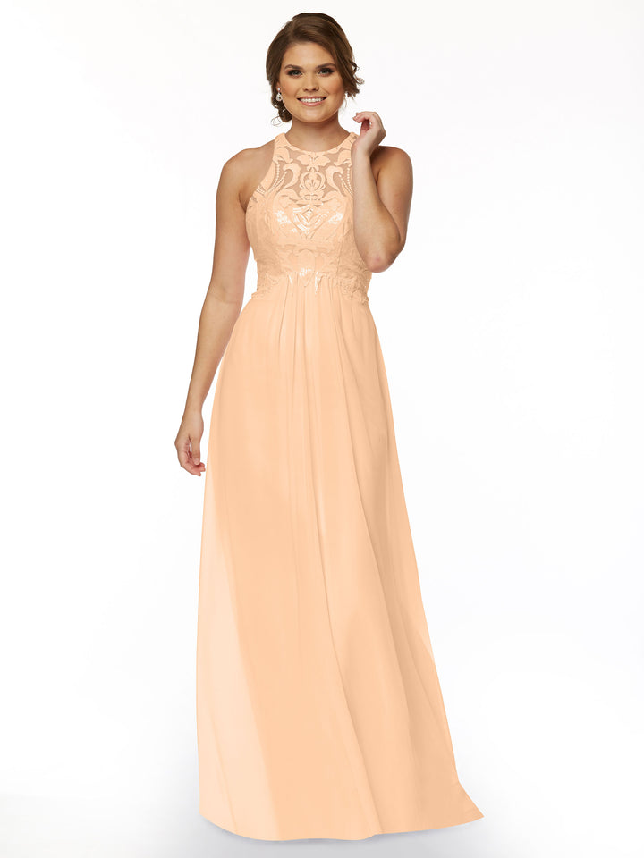 A woman wearing Avery Austin’s TH-80084, a sleeveless floor-length peach gown with a chiffon skirt and lace bodice, smiles against a plain white background.