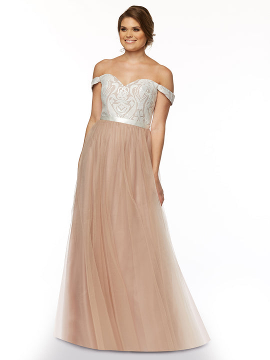 A woman wearing the Avery Austin TH-80085 gown in Buff/Ivory, featuring a lace off-shoulder design with a white embroidered bodice and flowing blush A-line tulle skirt, smiles against a plain white background.