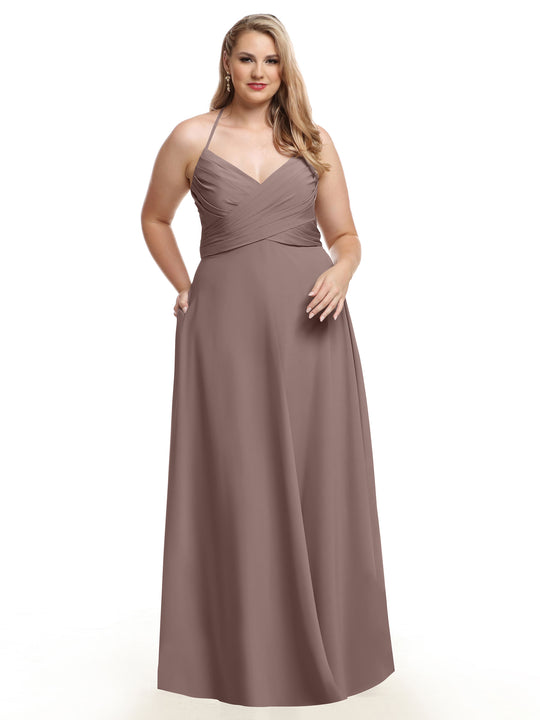 A woman models the Avery Austin TH-80101: a sleeveless, floor-length mauve A-line dress with a V-neckline and pleated bodice, standing against a white background.