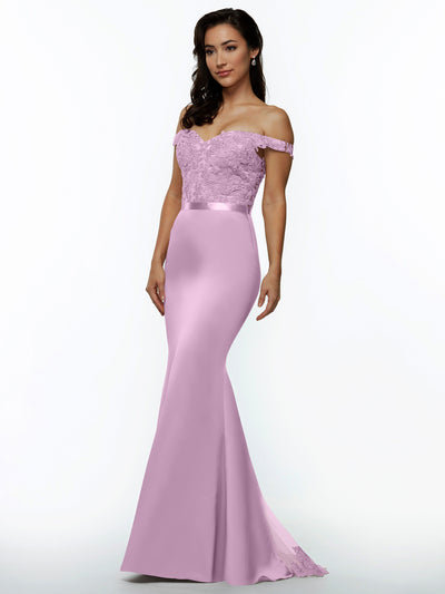 A woman models Avery Austin's 80104: an off-the-shoulder, floor-length lavender bridesmaid dress featuring a lace bodice and satin skirt, standing gracefully against a plain white background.