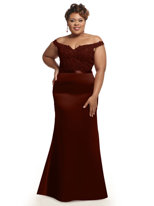 A woman stands with one hand on her hip, smiling in the Avery Austin TH-80104 burgundy off-the-shoulder bridesmaid dress with lace bodice detailing, posed against a white background.