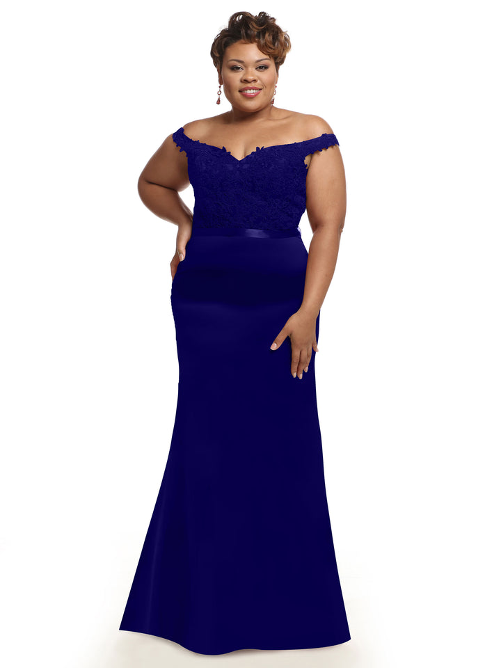 A woman stands confidently, smiling, in Avery Austin&