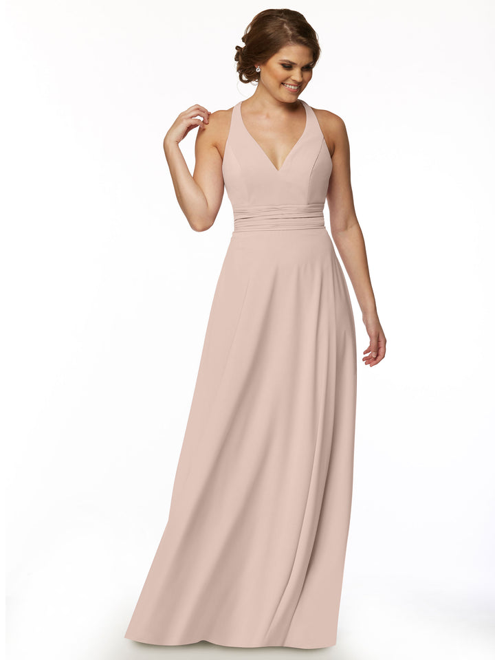 A woman wearing the Avery Austin 80107 sleeveless, floor-length blush pink A-line dress with a fitted bodice and V-neckline stands smiling against a plain white background.