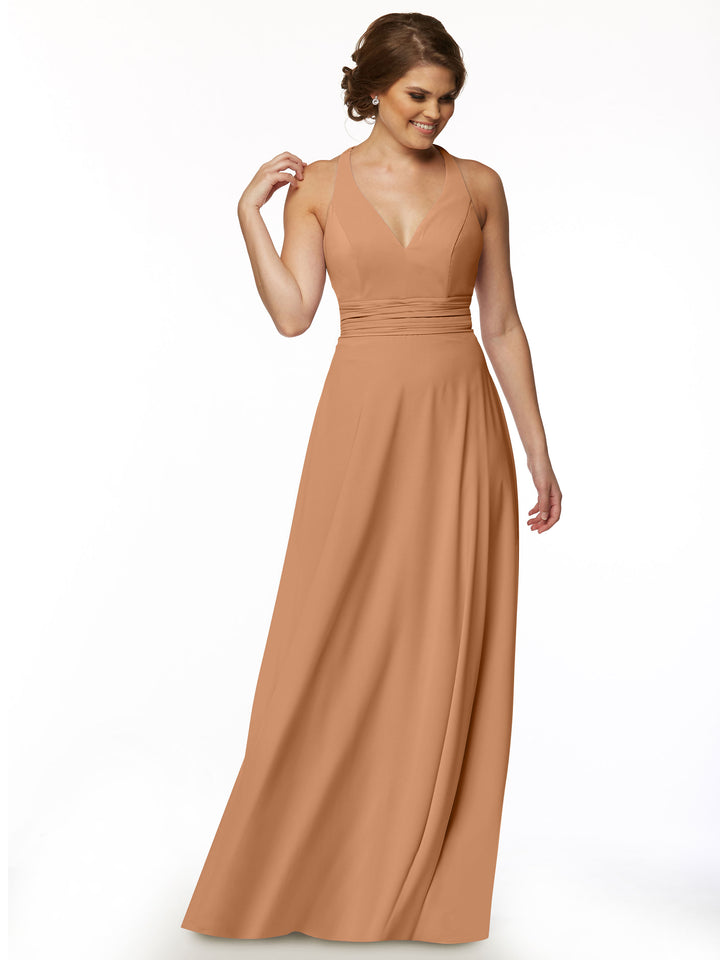 A woman models Avery Austin’s 80107: a sleeveless, floor-length light brown A-line dress with a deep V-neckline, standing against a white background and smiling to her left for a feminine look.