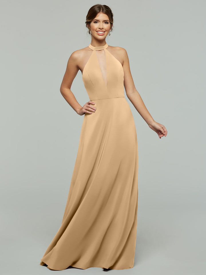 A woman smiles against a plain light gray background wearing the Avery Austin 80115: a sleeveless, floor-length tan halter A-line dress with a front sheer panel.