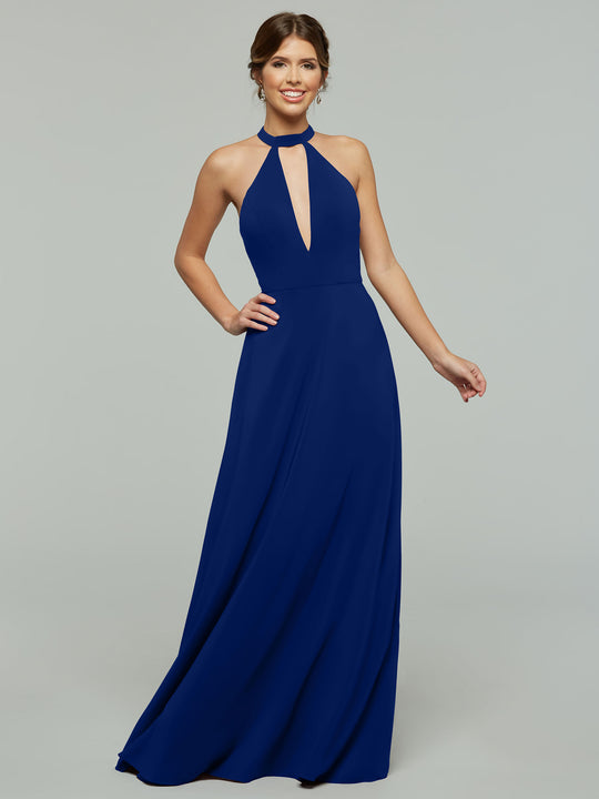 A woman wearing Avery Austin's 80115: a sleeveless, floor-length royal blue halter A-line dress with a front keyhole cutout, stands smiling against a plain gray background.
