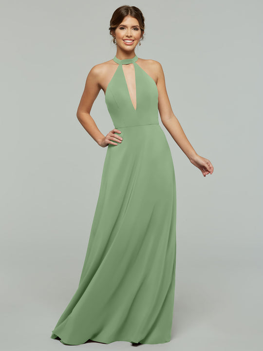 A woman stands smiling against a plain light gray background, wearing the Avery Austin 80115: a sleeveless, floor-length sage green halter A-Line dress with a keyhole front.