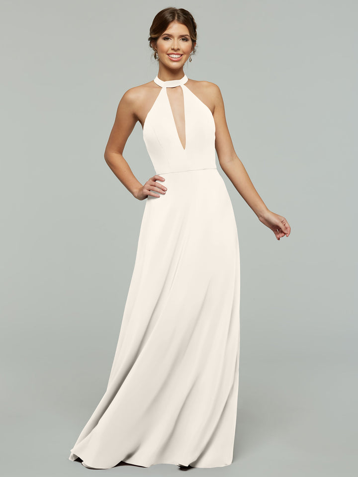 A woman smiles against a plain gray background, wearing Avery Austin’s 80115—a sleeveless, floor-length white halter A-line dress with a front keyhole cutout.