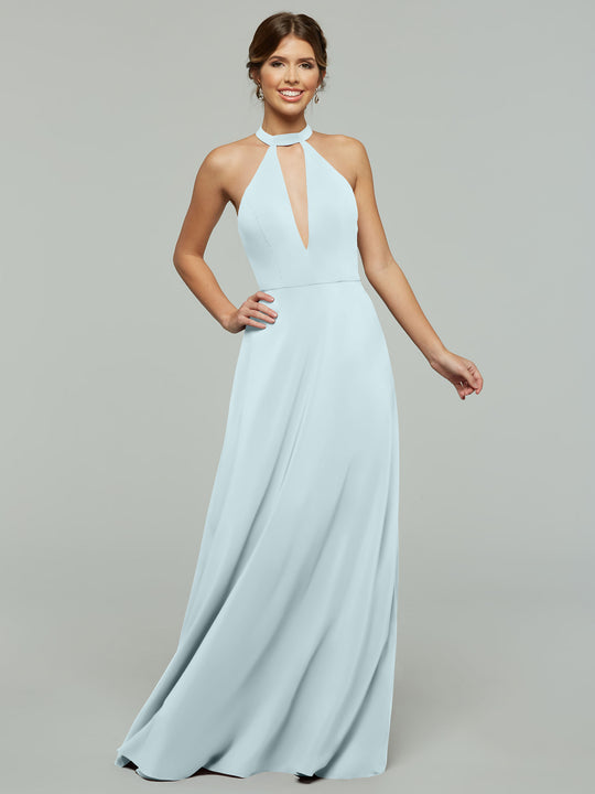 A woman smiles as she models Avery Austin’s sky blue, floor-length halter A-Line dress (style 80115) with a keyhole neckline and flowing skirt, set against a plain gray background.