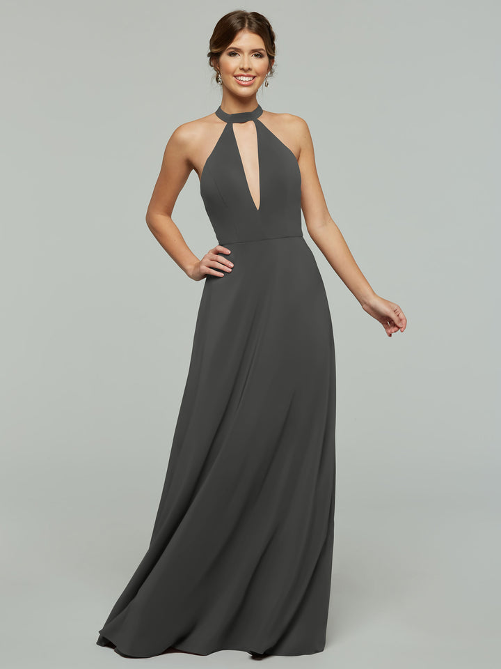 A woman smiles against a light gray background wearing the Avery Austin 80115 sleeveless, floor-length dark gray halter A-line dress with a front keyhole cutout.