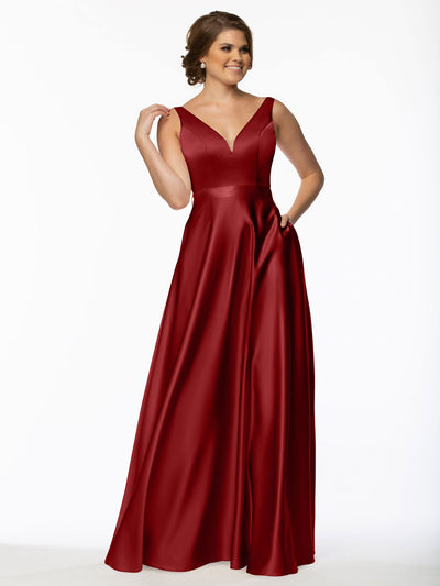 A woman wearing Avery Austin's 80118 sleeveless deep red satin bridesmaid dress with a V-neckline and floor-length skirt smiles against a plain white background.
