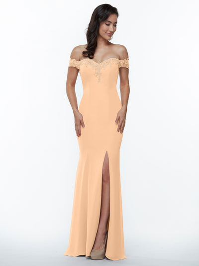A woman in Avery Austin’s 80121 peach chiffon off-the-shoulder bridesmaid dress with lace bodice and thigh-high slit stands against a plain white background.
