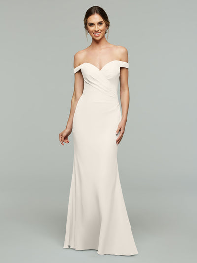 A woman models Avery Austin's 80122 off-the-shoulder bridesmaid dress—a fitted white gown with a sweetheart neckline and subtle draping—against a plain light gray background.