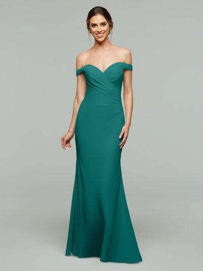 A woman smiles against a gray background wearing Avery Austin's style 80122, an off-the-shoulder, floor-length teal bridesmaid dress that is fitted at the waist and gently flares for an elegant silhouette.