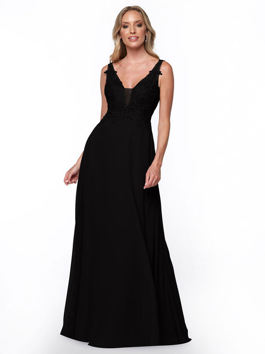 A woman with light hair smiles slightly while modeling Avery Austin’s black bridesmaid dress (style 80128), featuring a fitted lace bodice and a flowing chiffon skirt against a white background.