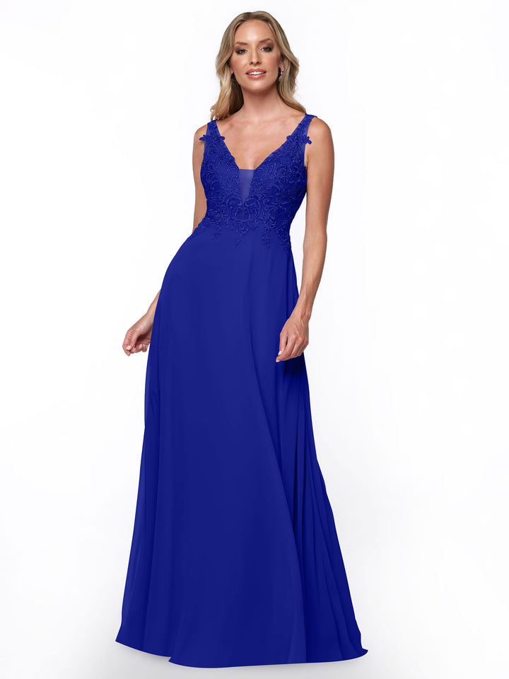 A woman wears Avery Austin’s cobalt 80128 bridesmaid dress, featuring a sleeveless, lace-embroidered fitted bodice and flowing chiffon floor-length skirt, standing against a plain white background.
