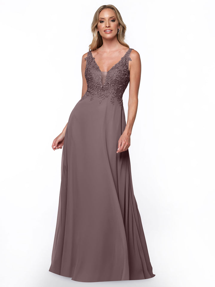 A woman models the Avery Austin TH-80128, a mauve bridesmaid dress with a lace bodice, deep V-neckline, and flowing chiffon skirt, standing against a plain white background.