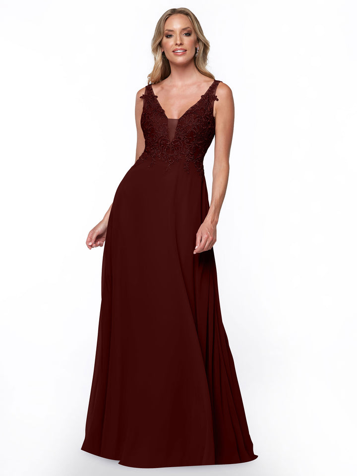 A woman in the Avery Austin TH-80128 merlot bridesmaid dress, featuring a sleeveless fitted lace bodice and a flowing chiffon skirt, stands and smiles against a plain white background.