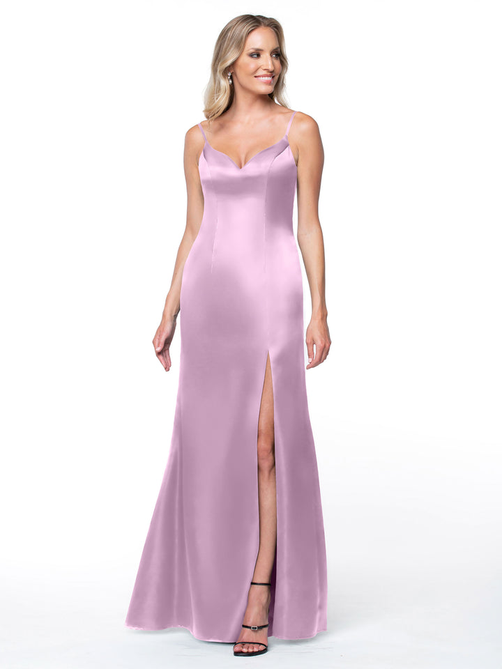 A woman poses against a white background in the Avery Austin 80132 light purple satin slit dress with thin straps, a fitted bodice, and detailed back, styled with black high-heeled sandals.