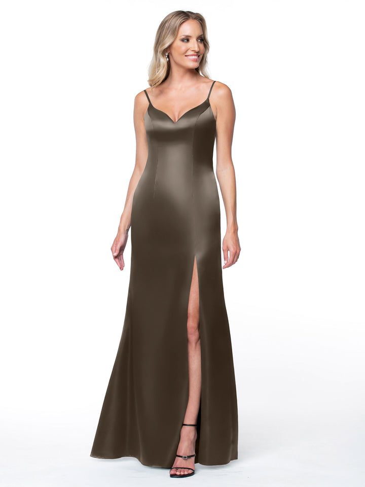 A woman in the Avery Austin 80132 sleeveless bronze satin dress with thin straps and a high slit stands against a white background, smiling and looking to the side.