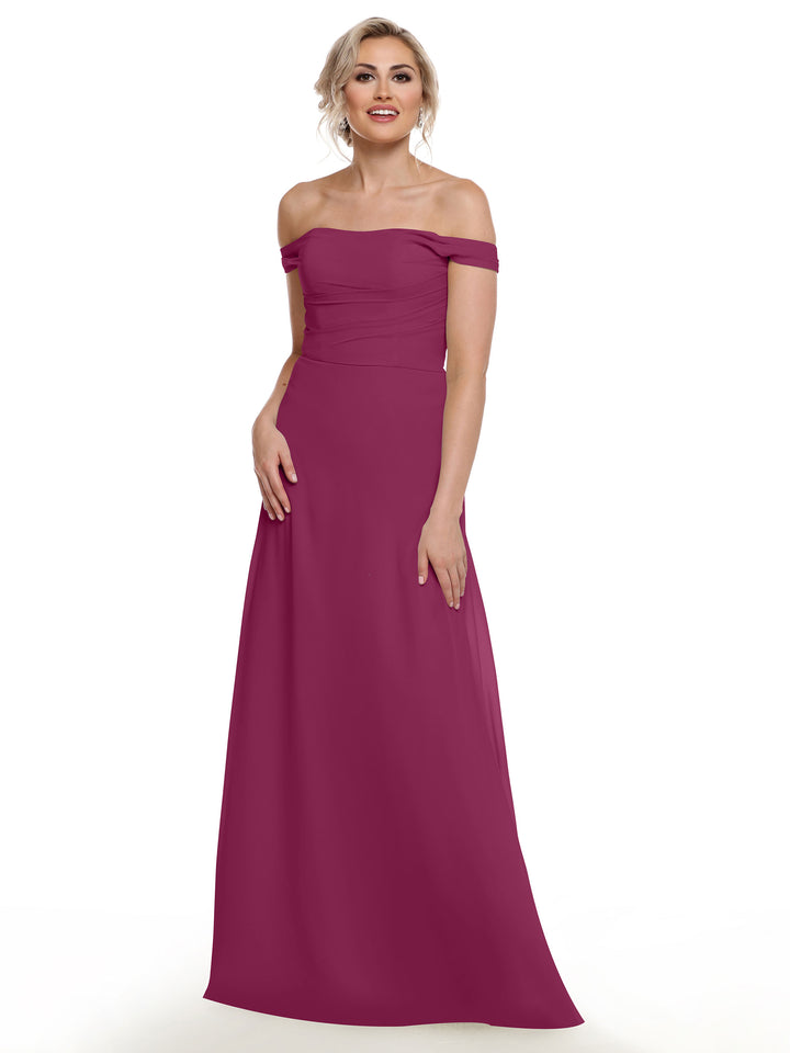 A woman smiles against a white background wearing Avery Austin’s 80136, an off-the-shoulder, floor-length magenta chiffon dress.