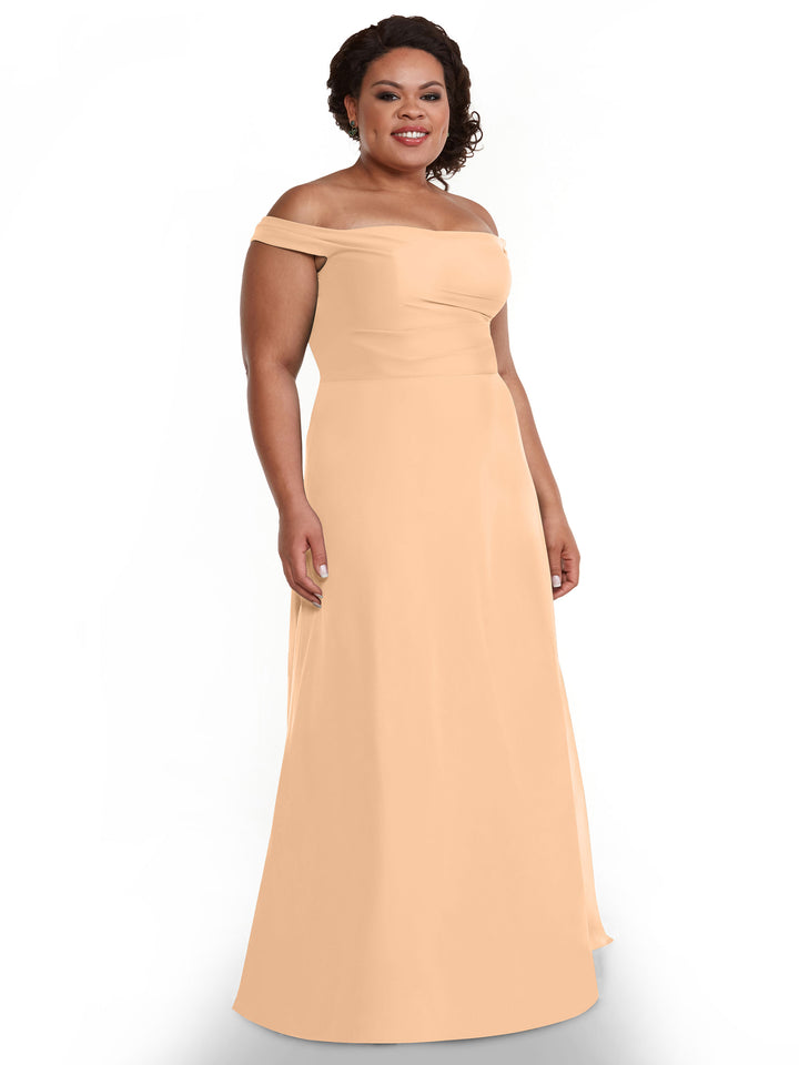 A woman in Avery Austin’s 80136, a peach, floor-length chiffon dress.