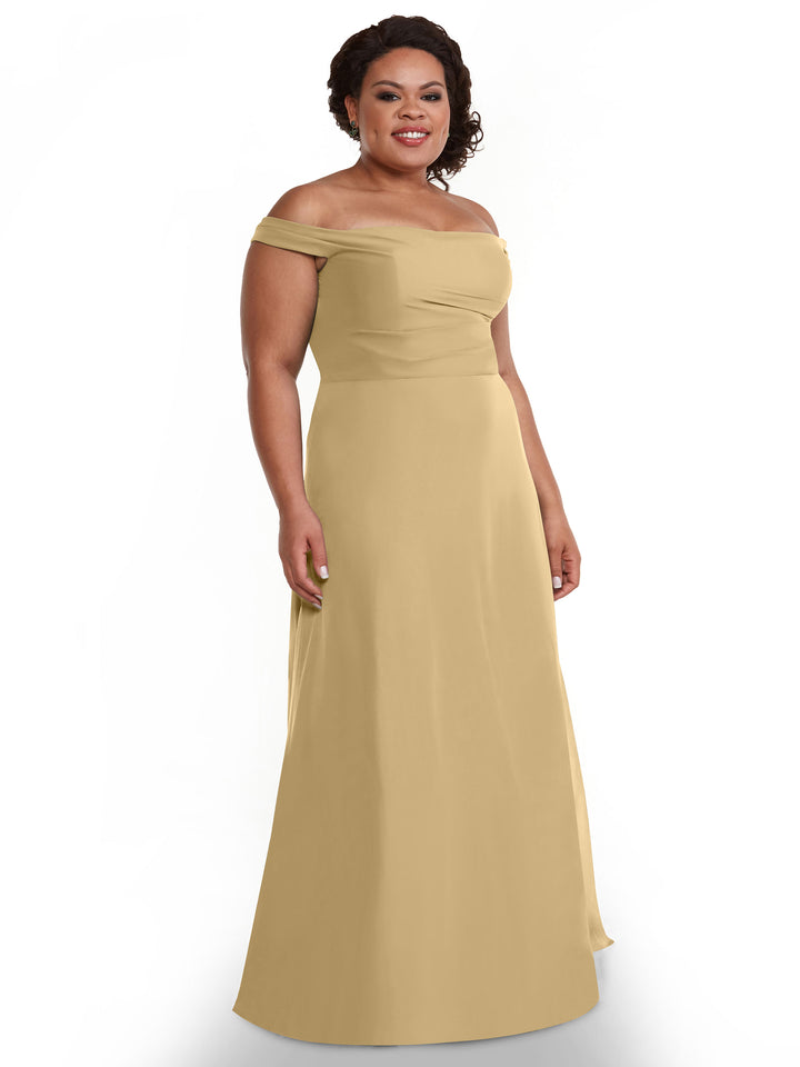 A woman with short curly hair smiles against a plain white background, wearing Avery Austin&