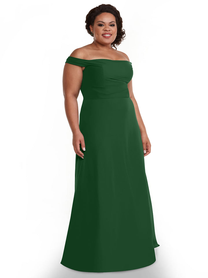 A woman in the Avery Austin TH-80136 off-the-shoulder, floor-length chiffon dress stands smiling against a plain white background.