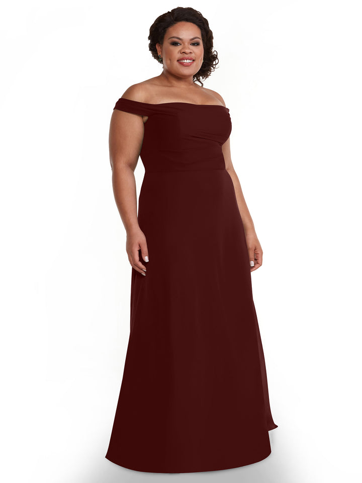 A woman smiles against a white background, wearing Avery Austin&