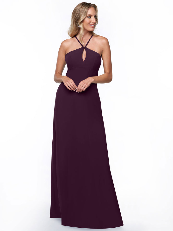 Model wears Avery Austin’s 80137: a floor-length, sleeveless dark purple halter dress with a small front keyhole, shown against a plain white background for a minimalist look.