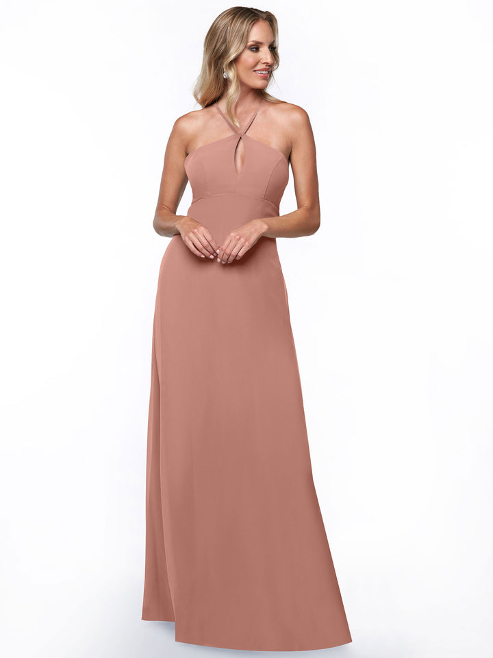 A woman models the Avery Austin 80137, a sleeveless, floor-length dusty rose halter dress with a keyhole back, standing against a plain white background.