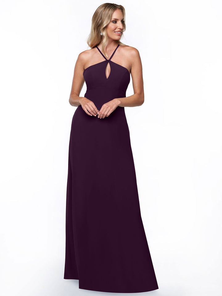 Model wears Avery Austin’s 80137: a sleeveless, floor-length dark purple halter dress with a keyhole cutout and minimalistic design, set against a plain white background.