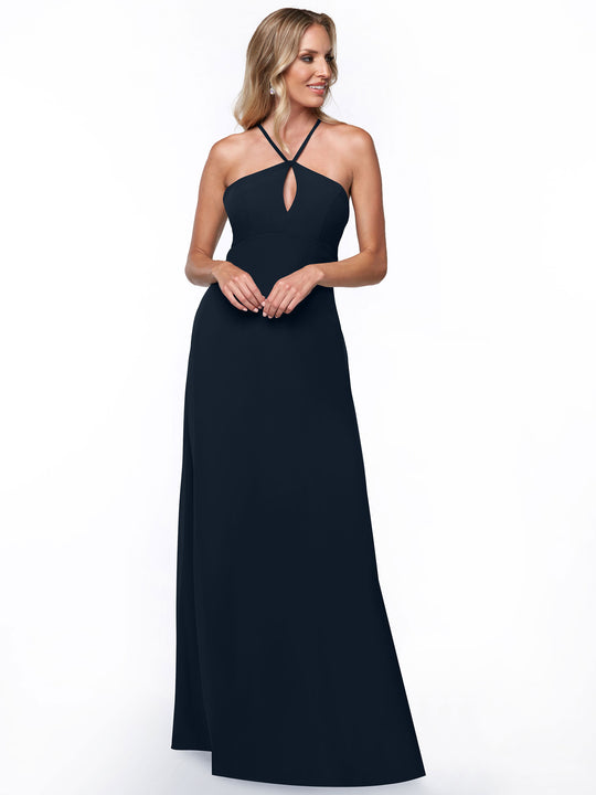 Model wears Avery Austin 80137, a long sleeveless dark navy halter dress with a keyhole cutout. She has light, wavy hair and is gently smiling against a plain white background.