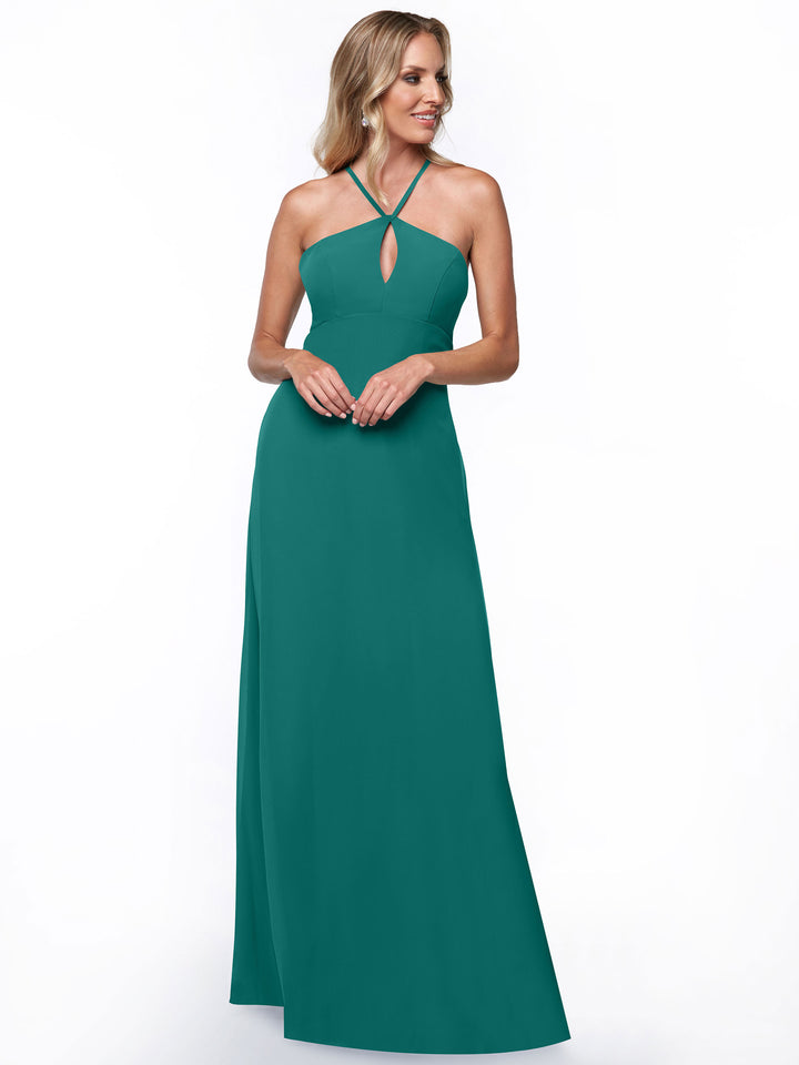 A woman models the Avery Austin 80137, a teal, floor-length halter dress with a sleeveless keyhole back, standing against a plain white background.