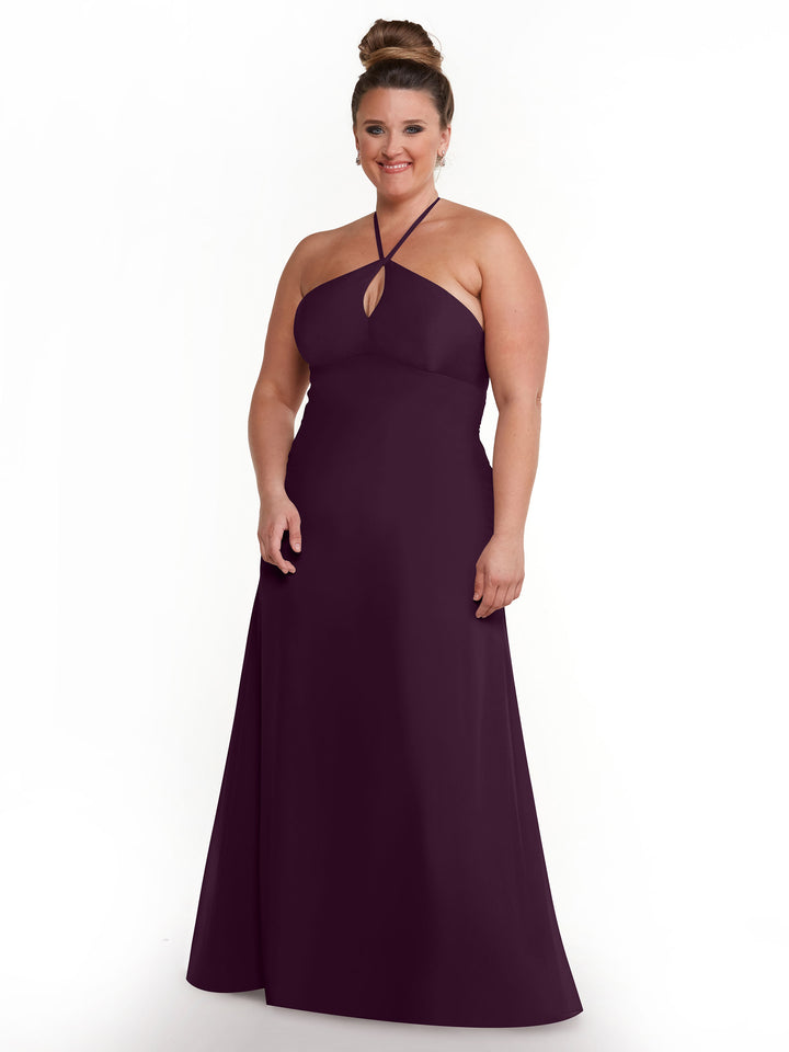 A woman smiles in front of a white background, modeling Avery Austin&