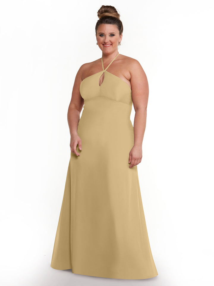 A woman smiles in Avery Austin’s 80137, a minimalistic halter dress with a keyhole cutout and long, sleeveless silhouette. Her hair is styled in a high bun, set against a plain white background.