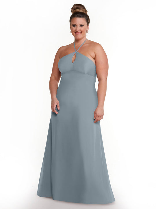 A woman smiles against a white background, modeling the Avery Austin 80137—a light blue, floor-length halter dress with a keyhole detail that highlights an elegant, minimalistic style.