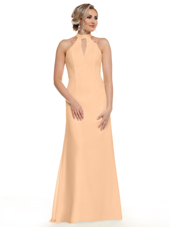 Wearing the Avery Austin 80138 gown, a woman poses against a white background in a sleeveless, floor-length peach dress with a halter neckline and keyhole cutout that highlights her shoulders.