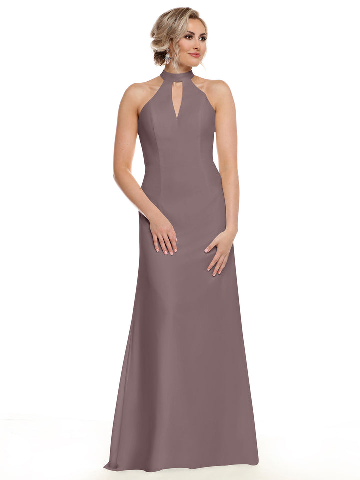 A woman models Avery Austin’s 80138, a sleeveless mauve gown with a halter neckline and front keyhole, standing against a white background. Her hair is in an updo, and she has a neutral expression.