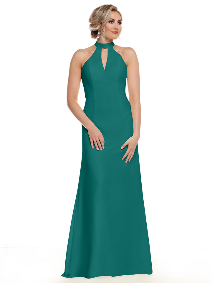 A woman models Avery Austin’s 80138 sleeveless, floor-length teal gown with a halter neckline and open back, showcasing her shoulders against a plain white background.