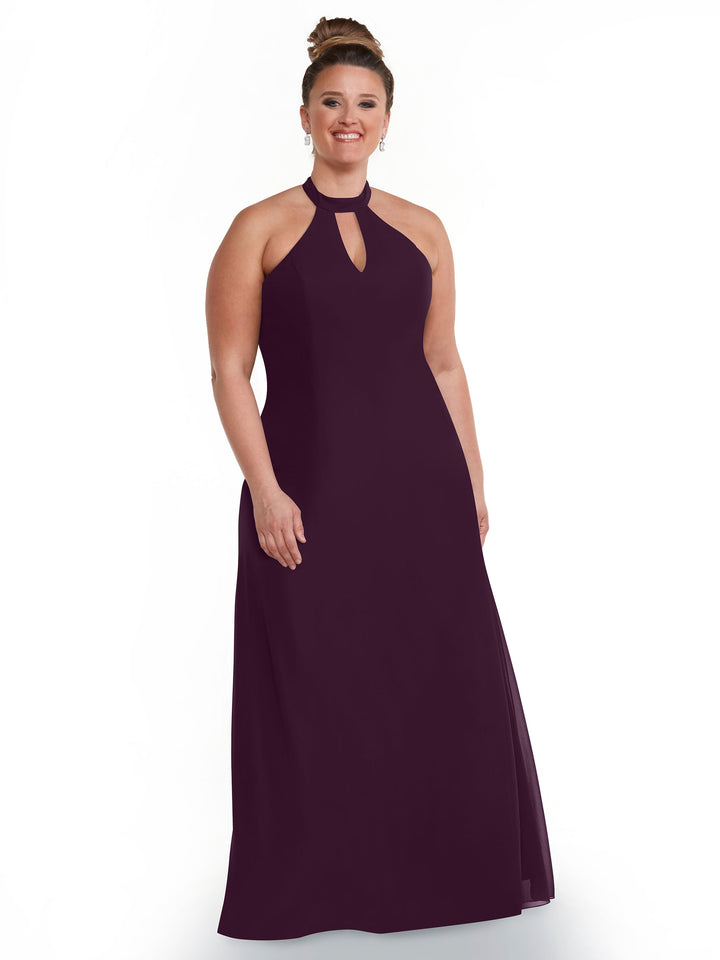 A woman with brown hair in a bun smiles against a white background wearing Avery Austin’s 80138, a sleeveless, floor-length dark purple halter dress featuring an open back and keyhole neckline.