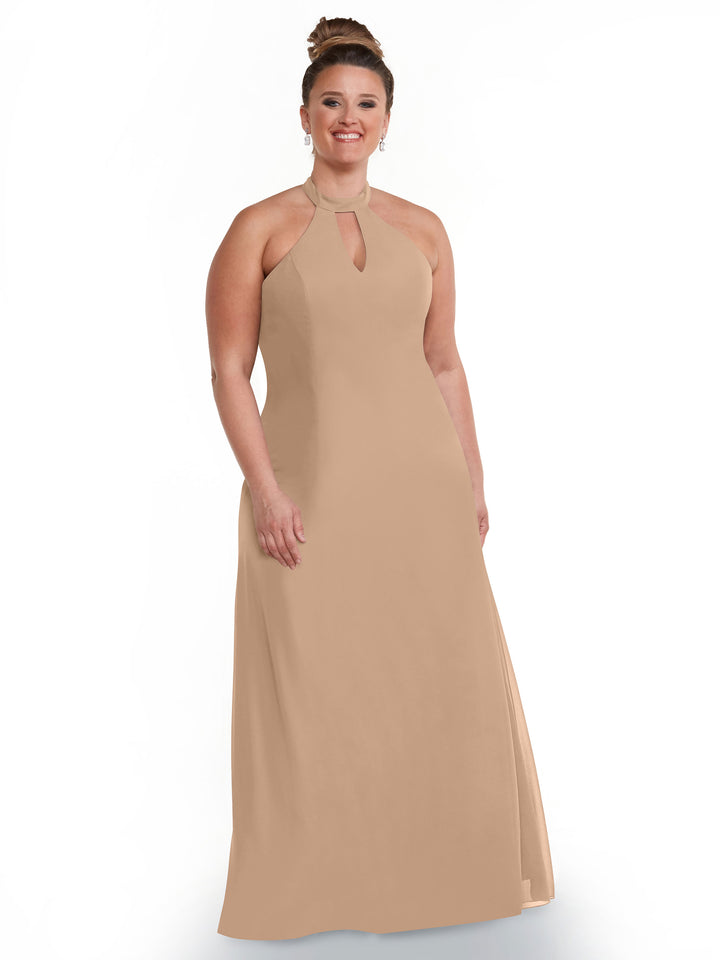 A woman with her hair in a bun smiles against a white background, modeling Avery Austin’s sleeveless, floor-length light beige halter dress (style 80138) featuring an open back and keyhole neckline.