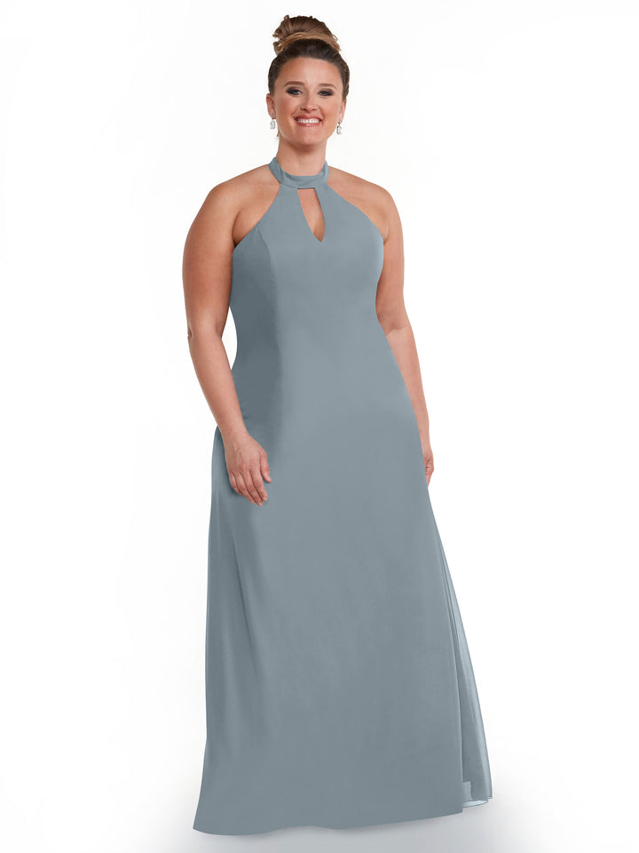 A woman smiles in the Avery Austin 80138 gown, a floor-length slate blue dress featuring a halter neckline and keyhole cutout. She wears her hair in an updo with earrings against a plain white background.