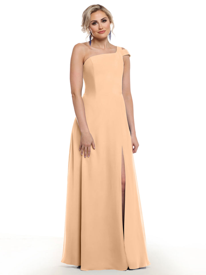 A woman wears the Avery Austin 80139, a blush sleeveless floor-length dress with an asymmetrical neckline and thigh-high side slit, standing against a plain white background.