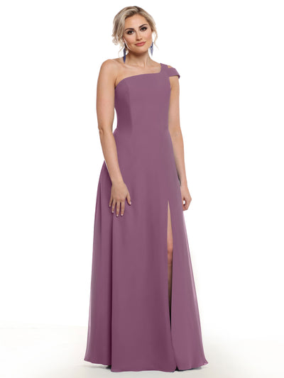 A woman in Avery Austin’s 80139, a mauve, sleeveless, floor-length gown with an asymmetrical neckline and thigh-high slit, stands against a white background.