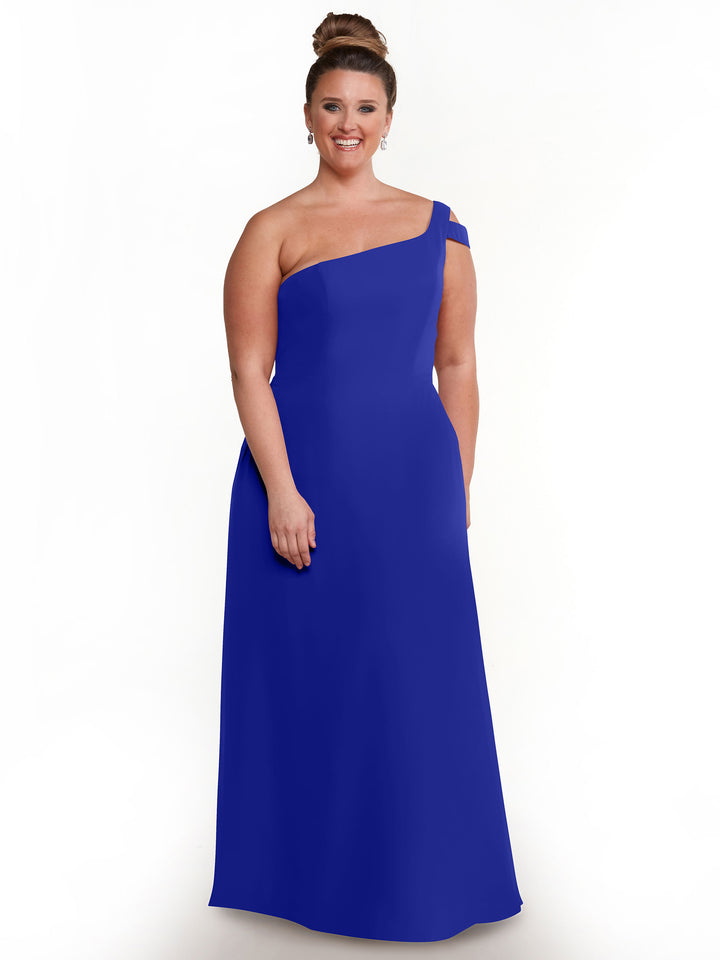 A woman smiles in the Avery Austin 80139 dress, featuring a sleek one-shoulder, floor-length silhouette in cobalt. With her hair in a high bun and drop earrings, she poses elegantly against a plain white background.