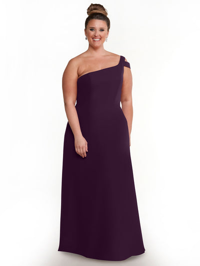 A woman smiles in the Avery Austin 80139, a sophisticated floor-length one-shoulder dark purple dress with an A-line silhouette. She poses gracefully with her hair in an updo against a plain white background.